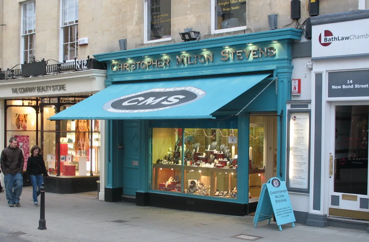 The teal shopfront and awning of Christopher Milton Stevens jewellers on a terraced street