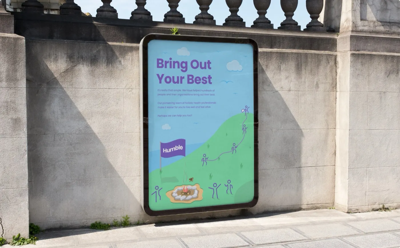 A Humble billboard reading "Bring Out Your Best" mounted on a stone wall in daylight